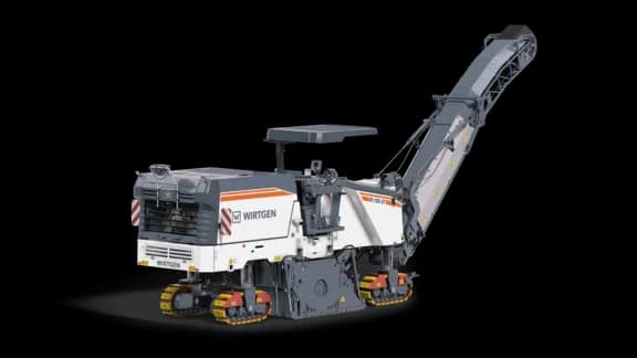 Wirtgen W 185 CF cold milling machine, a compact-class milling machine featuring an integrated primary crusher/conveyor system, tracked undercarriage, and milling drum designed for direct material loading and efficient recycling on road rehabilitation projects.