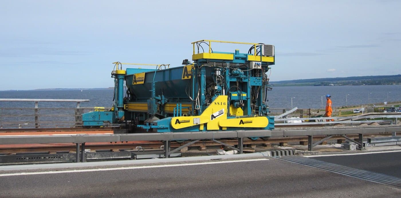 Slipform paver extruding a continuous concrete profile