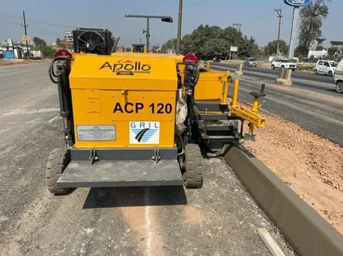 The Aptech ACP 120 is an automatic kerb paver machine, featuring a self-propelled tracked or wheeled chassis with an integrated concrete hopper and slipform mould system, designed for laying continuous concrete kerbs and channels along road edges.